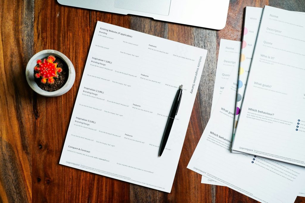 Printed resume pages and a pen on a desk, ready for an ATS check