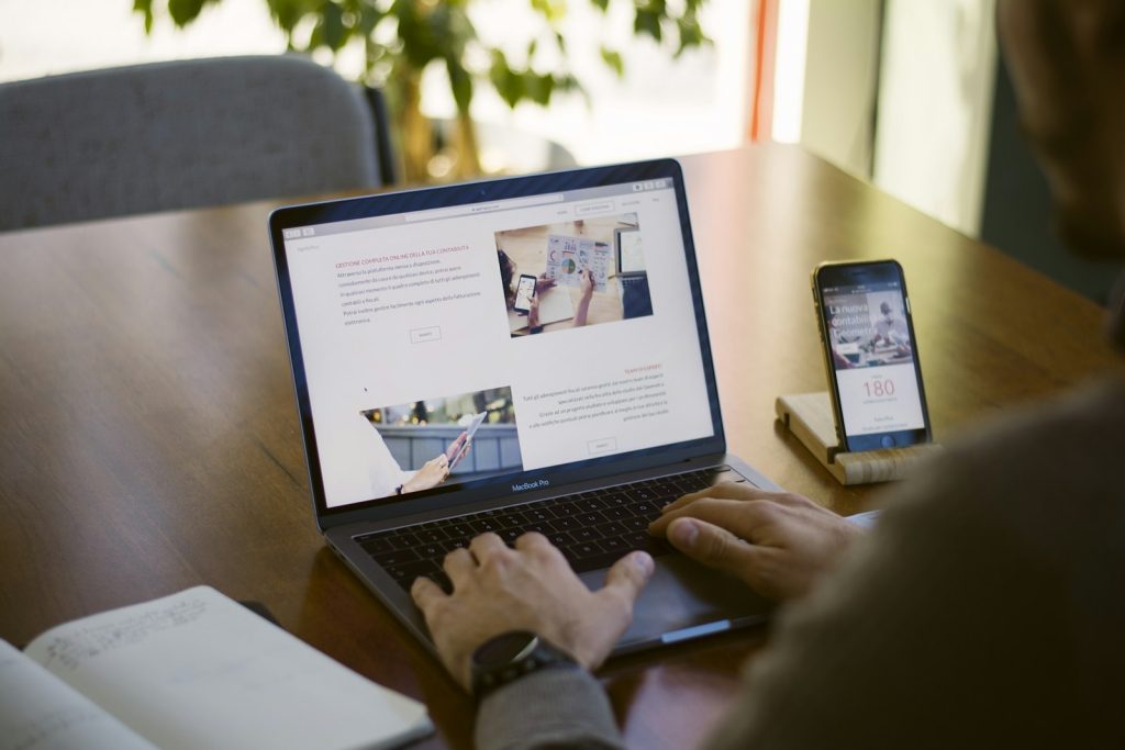 Candidate applying for IT jobs in Pune on a laptop and phone