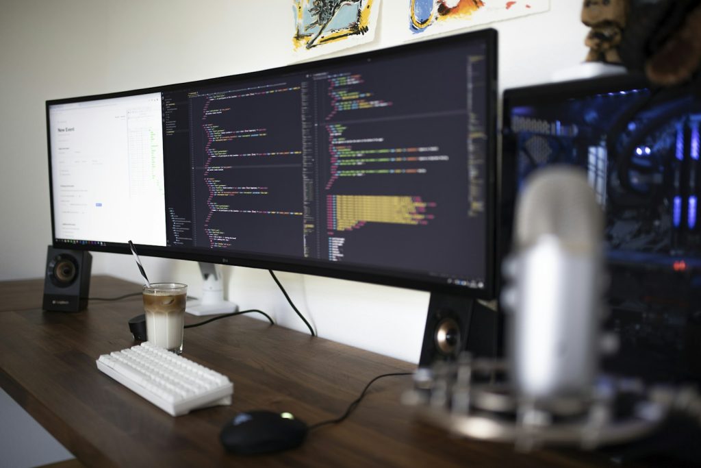 Test automation code on a wide monitor at a software tester's desk