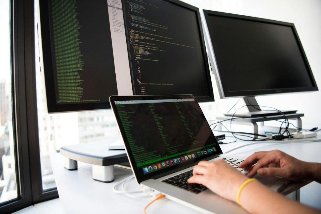 Automated software tests running on two monitors, practised in the software testing course in Pune